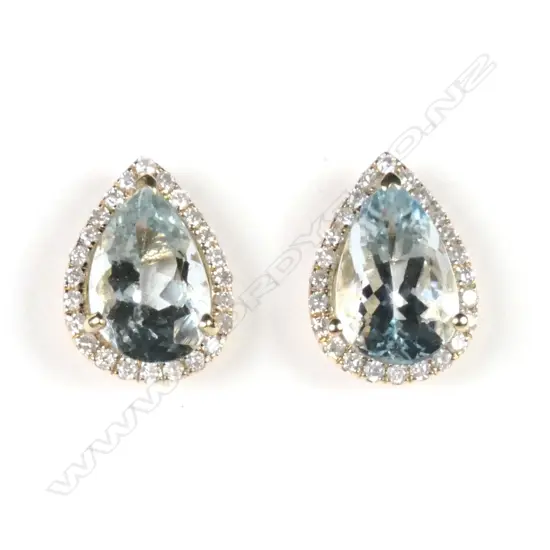 A pair of 14ct yellow gold aquamarine and diamond halo stud earrings