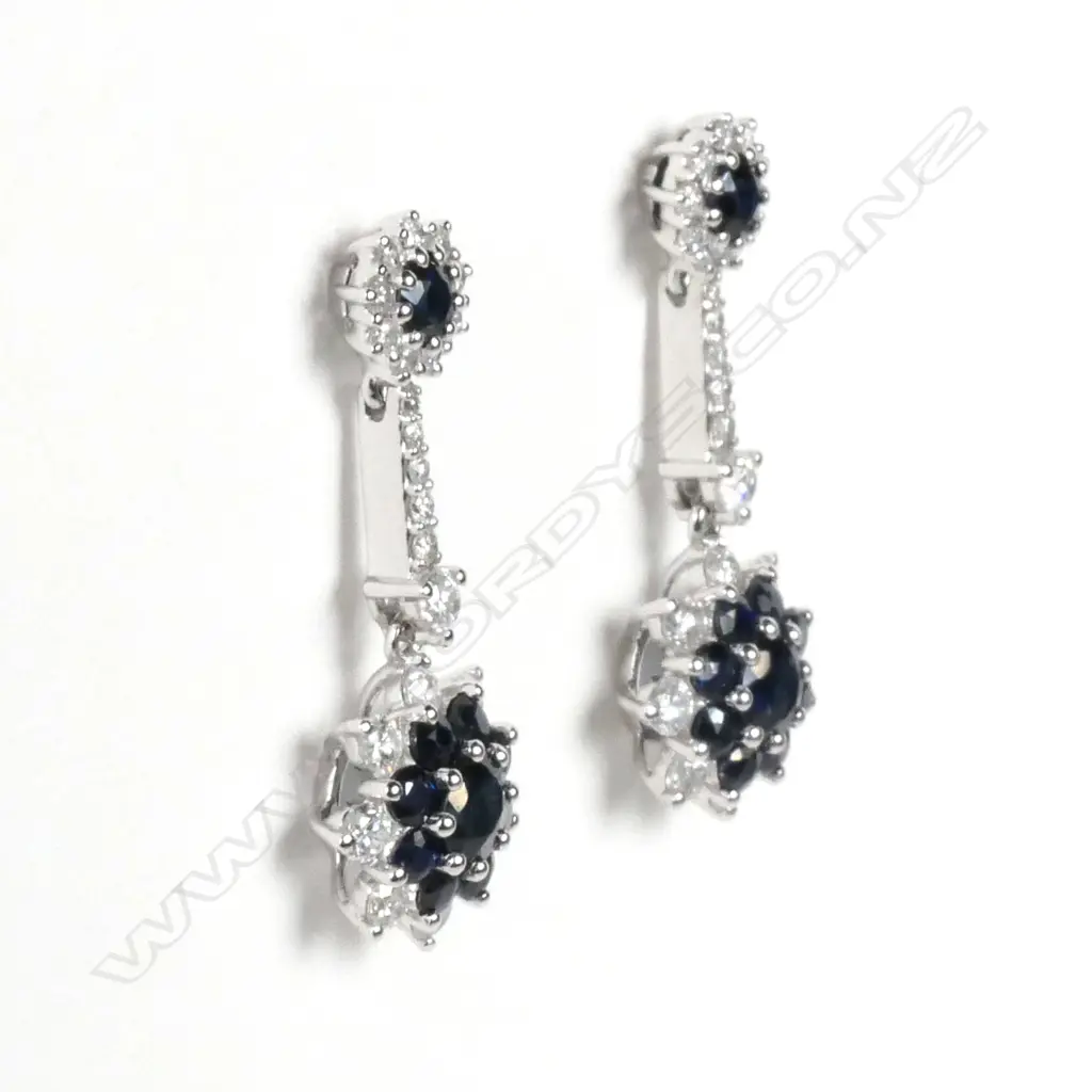 A pair of 14ct white gold sapphire and diamond flower design drop earrings Image 1++