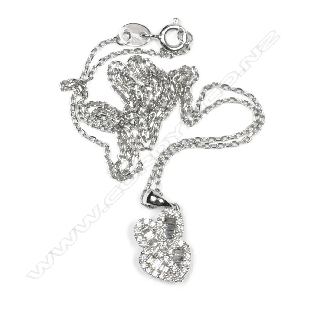 An 18ct white gold and diamond tiki face pendant Image 1++