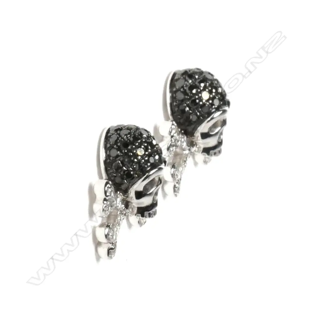 A pair of 18ct white gold and diamond skull and cross-bone earrings Image 1++