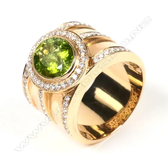 A large 18ct rose gold peridot and diamond ring