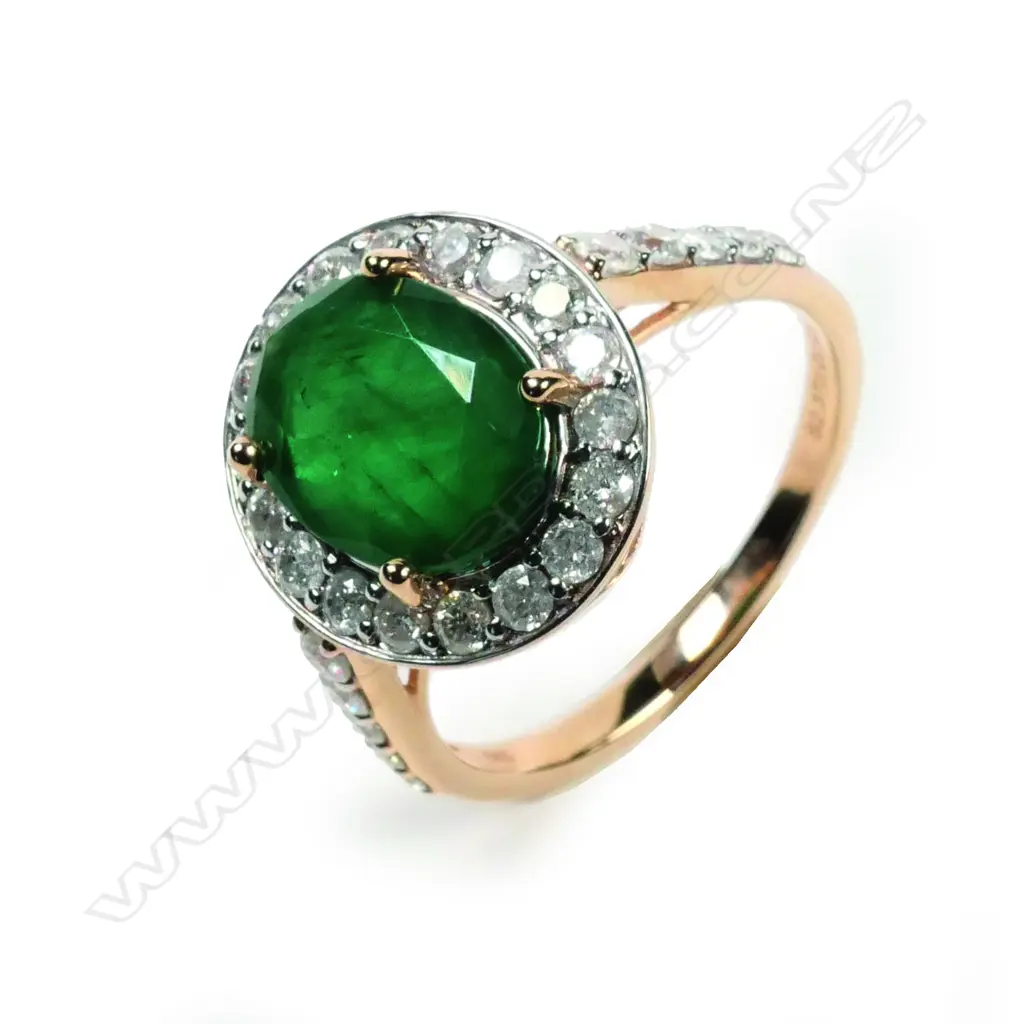 A 14ct rose gold emerald and diamond halo ring Image 1++