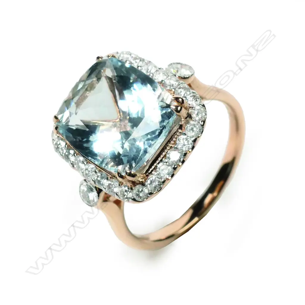 A 14ct rose gold aquamarine and diamond halo ring Image 1++