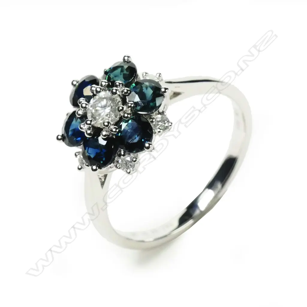 A 14ct white gold sapphire and diamond floral design ring Image 1++