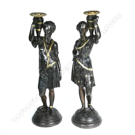 A pair of spelter figured candlesticks
