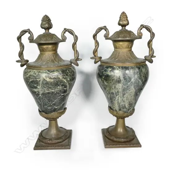 A pair of substantial granite and brass urns