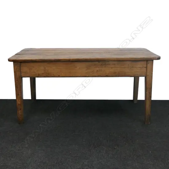A small French country fruitwood dining table