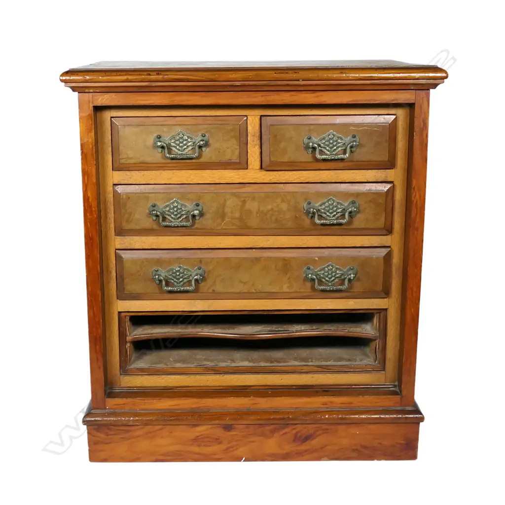 A colonial kauri apprentice chest, configured with four drawers and slots for paperwork at the base, mixed woods of kauri, totara and rewarewa, raised on plinth base. 440 x 270 x 500mm. Image 1++