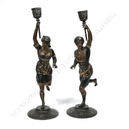 A pair of vintage spelter candlesticks