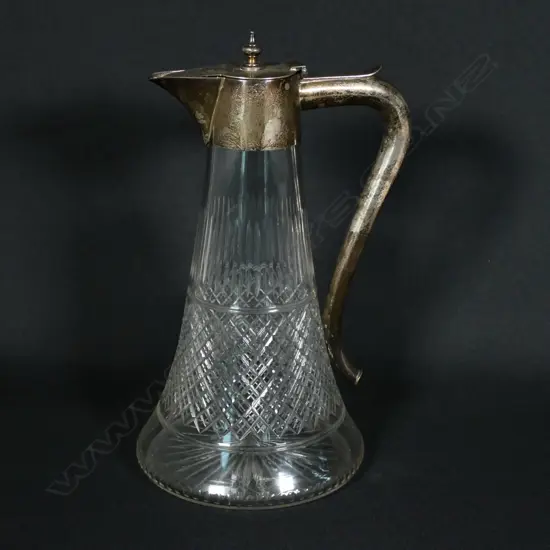 An Edwardian silver mounted cut crystal claret jug