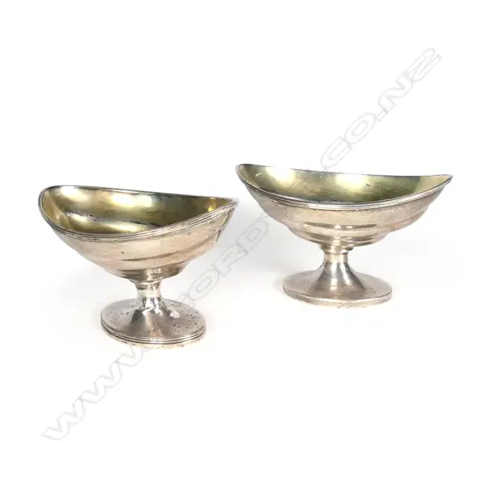 A pair of Georgian Scottish silver boat shaped salts on pedestal bases