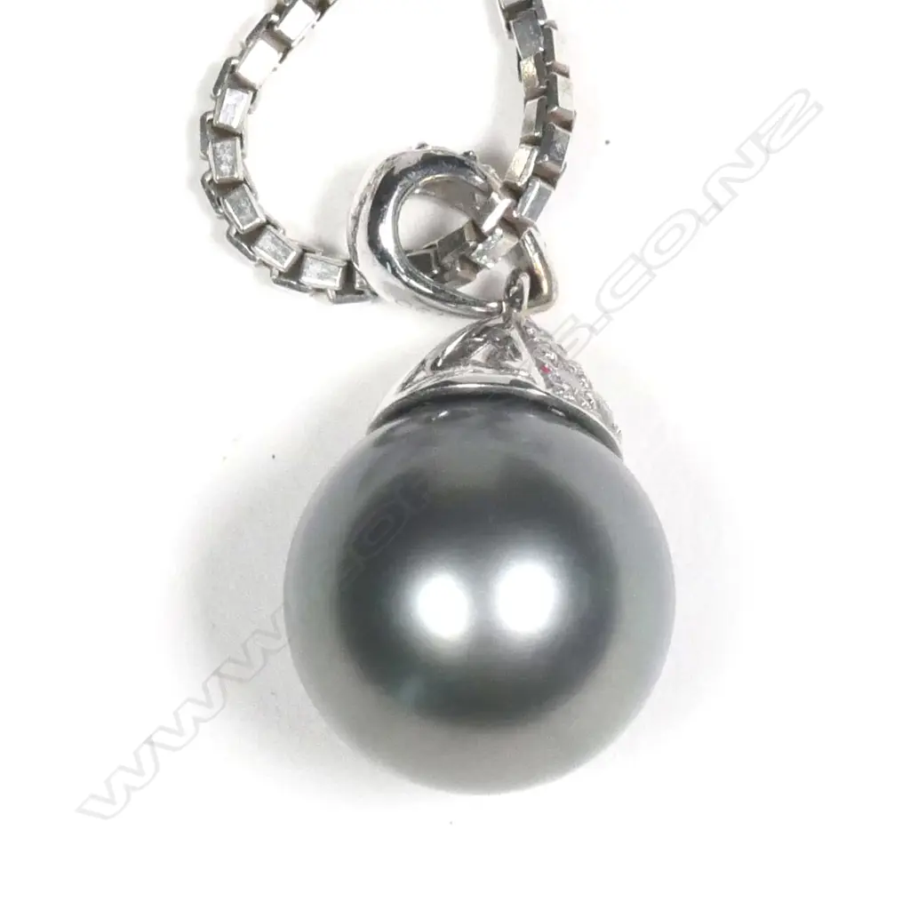 An 18ct white gold diamond and black pearl pendant Image 1++