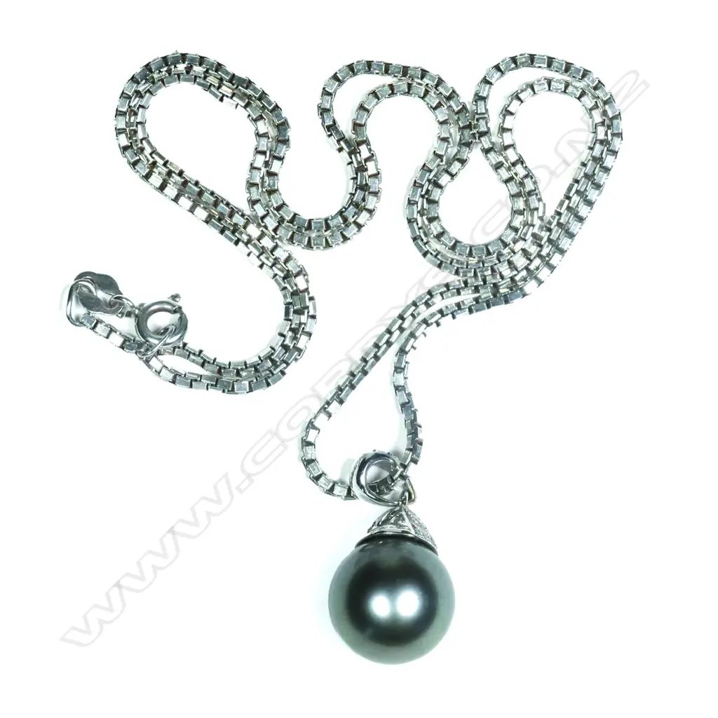 An 18ct white gold diamond and black pearl pendant Image 1++