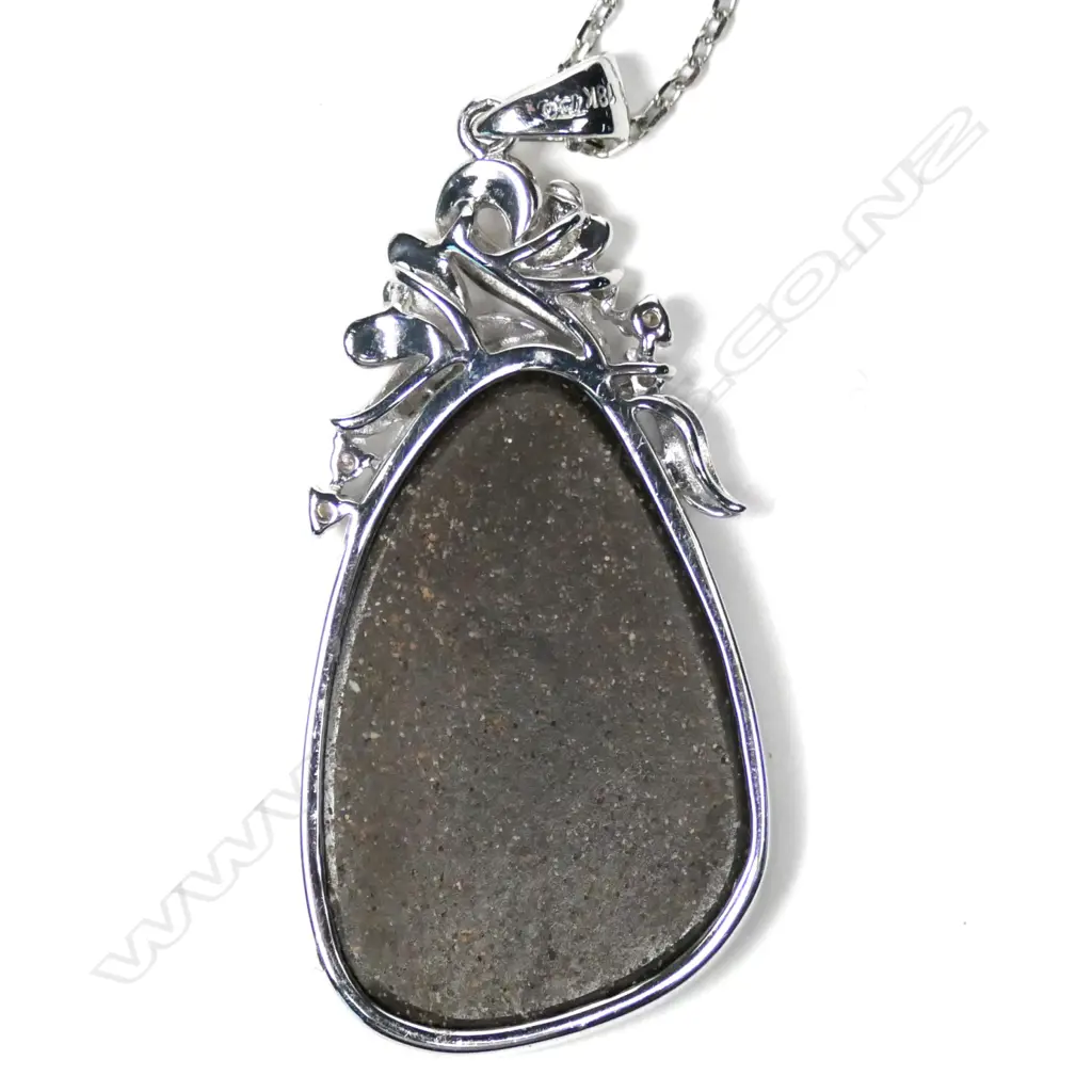 An 18ct white gold opal and diamond pendant Image 1++