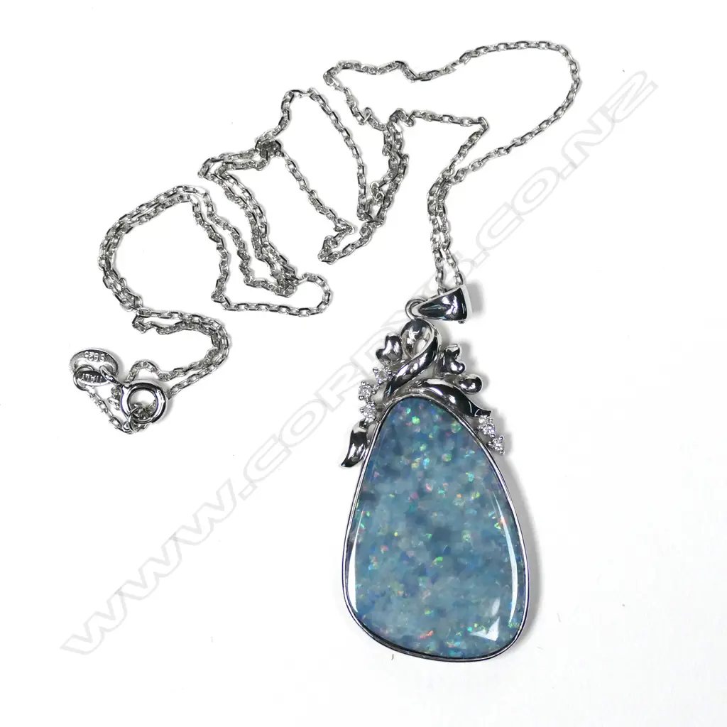 An 18ct white gold opal and diamond pendant Image 1++