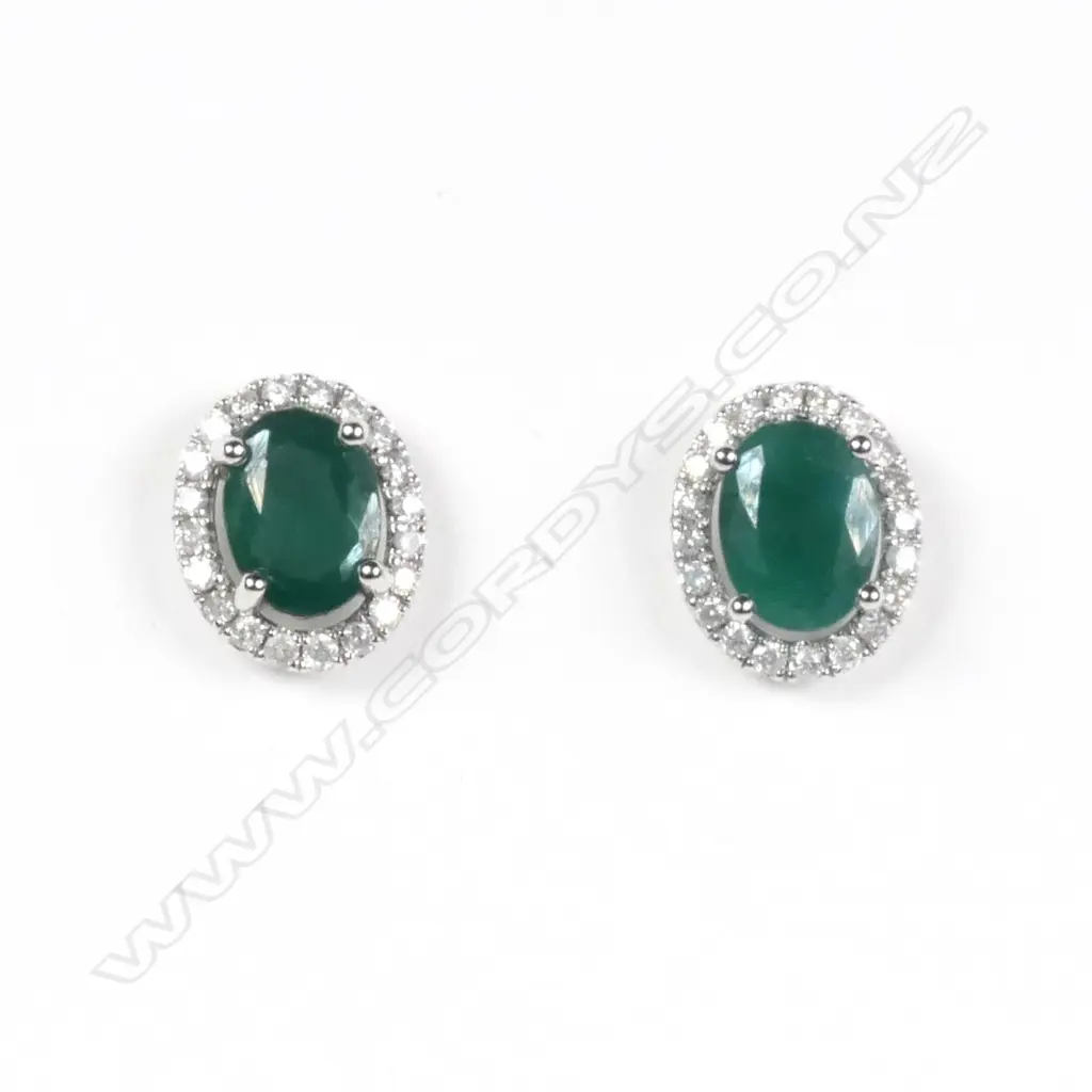 A pair of 14ct white gold emerald and diamond halo stud earrings Image 1++