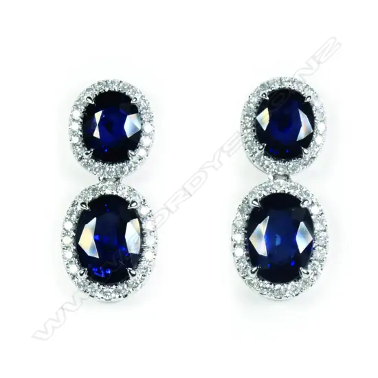 A pair of platinum tanzanite and diamond drop halo earrings