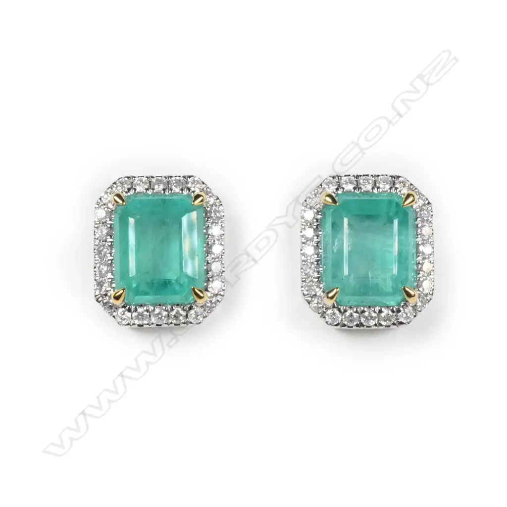 A pair of 14ct white gold Columbian emerald and diamond halo stud earrings Image 1++