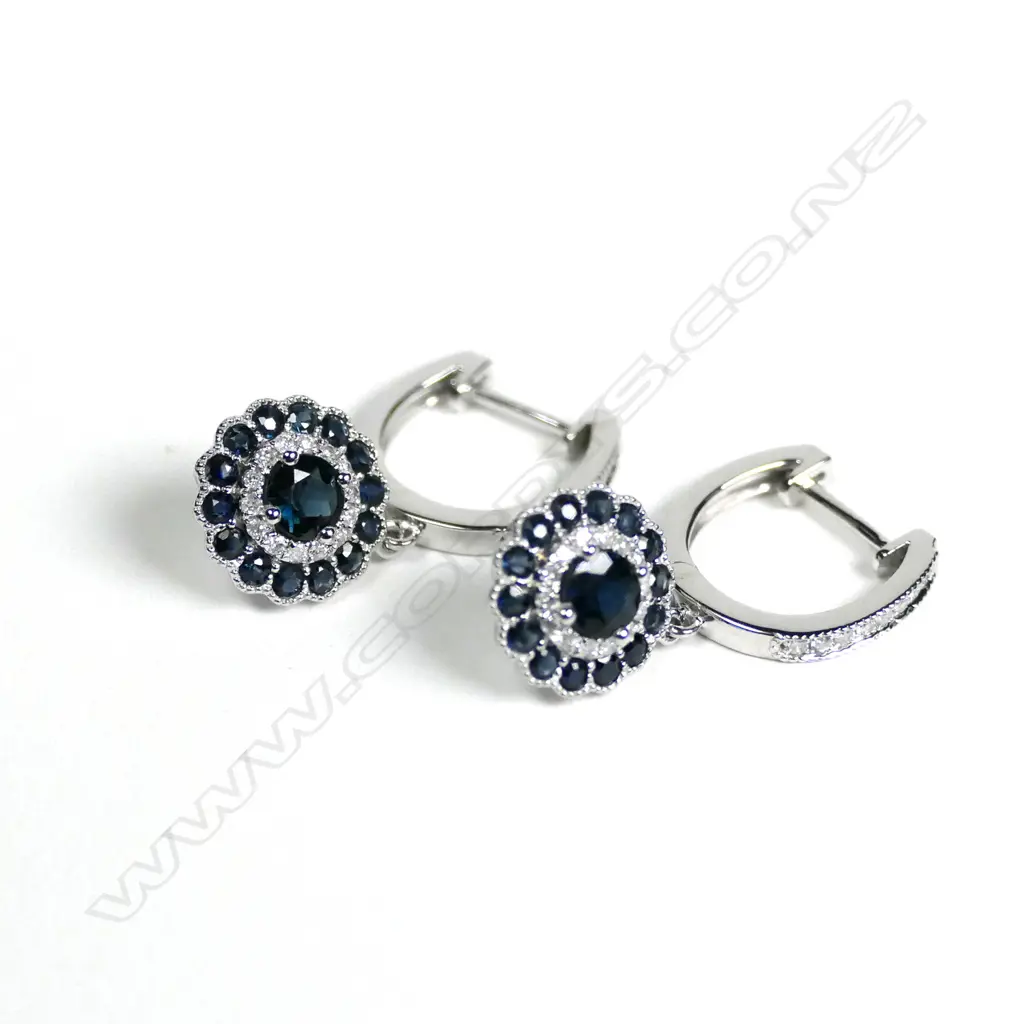 A pair of 14ct white gold Ceylonese sapphire and diamond huggie earrings Image 1++