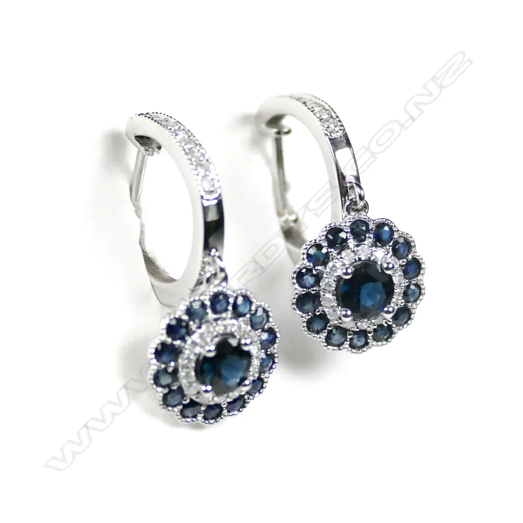 A pair of 14ct white gold Ceylonese sapphire and diamond huggie earrings Image 1++