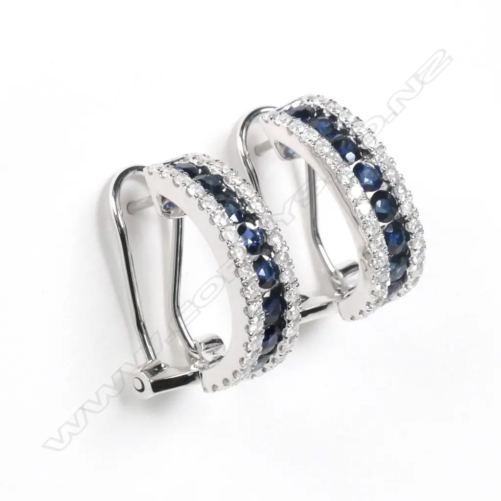 A pair of 14ct white gold sapphire and diamond earrings Image 1++