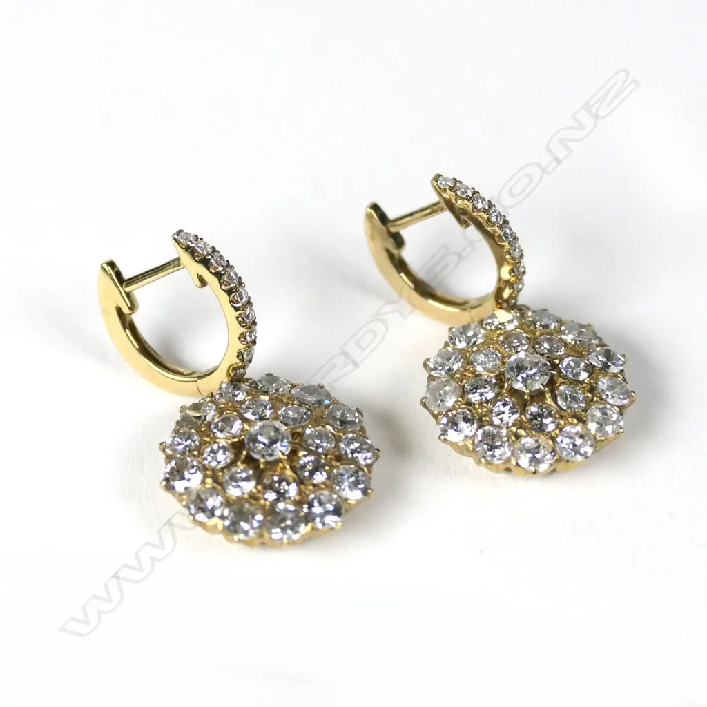 A pair of 18ct gold and diamond huggie earrings Image 1++