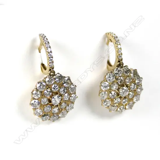 A pair of 18ct gold and diamond huggie earrings