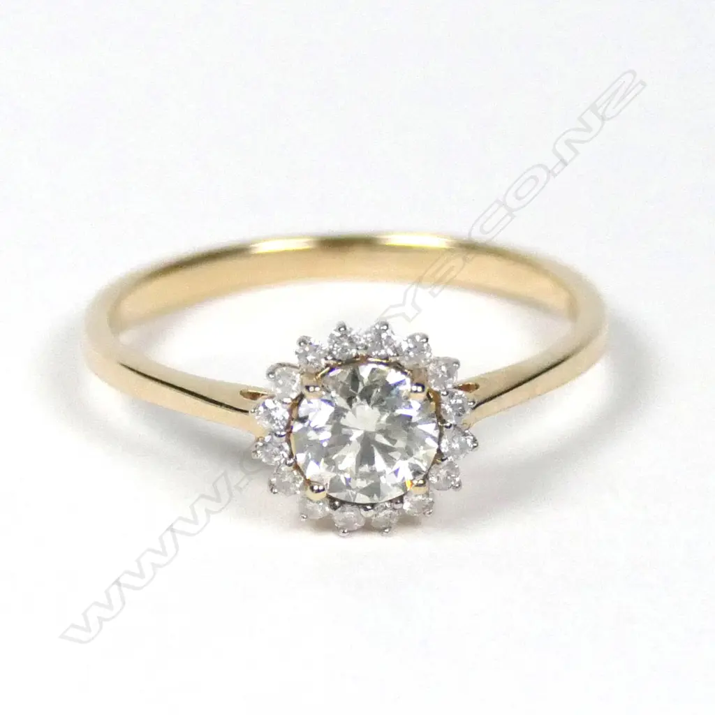 A 14ct yellow gold diamond halo ring Image 1++