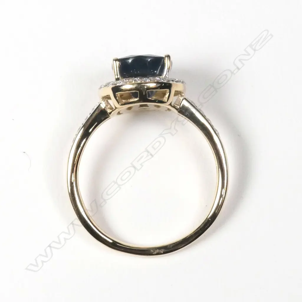 A 14ct yellow gold sapphire and diamond halo ring Image 1++