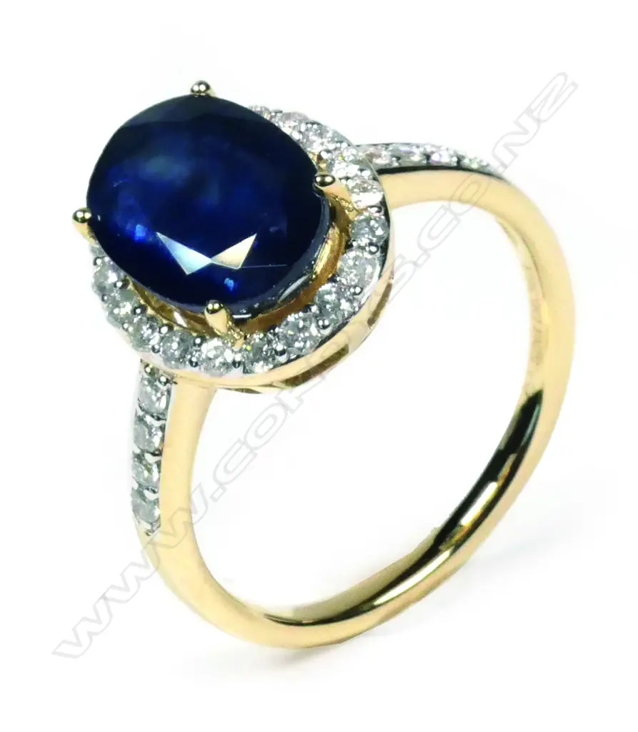 A 14ct yellow gold sapphire and diamond halo ring Image 1++