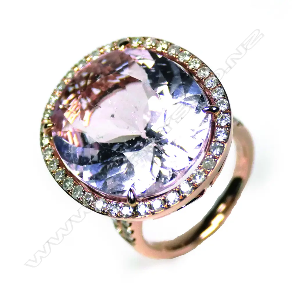 A 14ct rose gold kunzite and diamond halo ring Image 1++