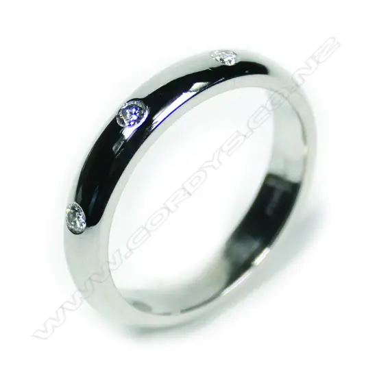 A modern 18ct white gold and three diamond gypsy type ring