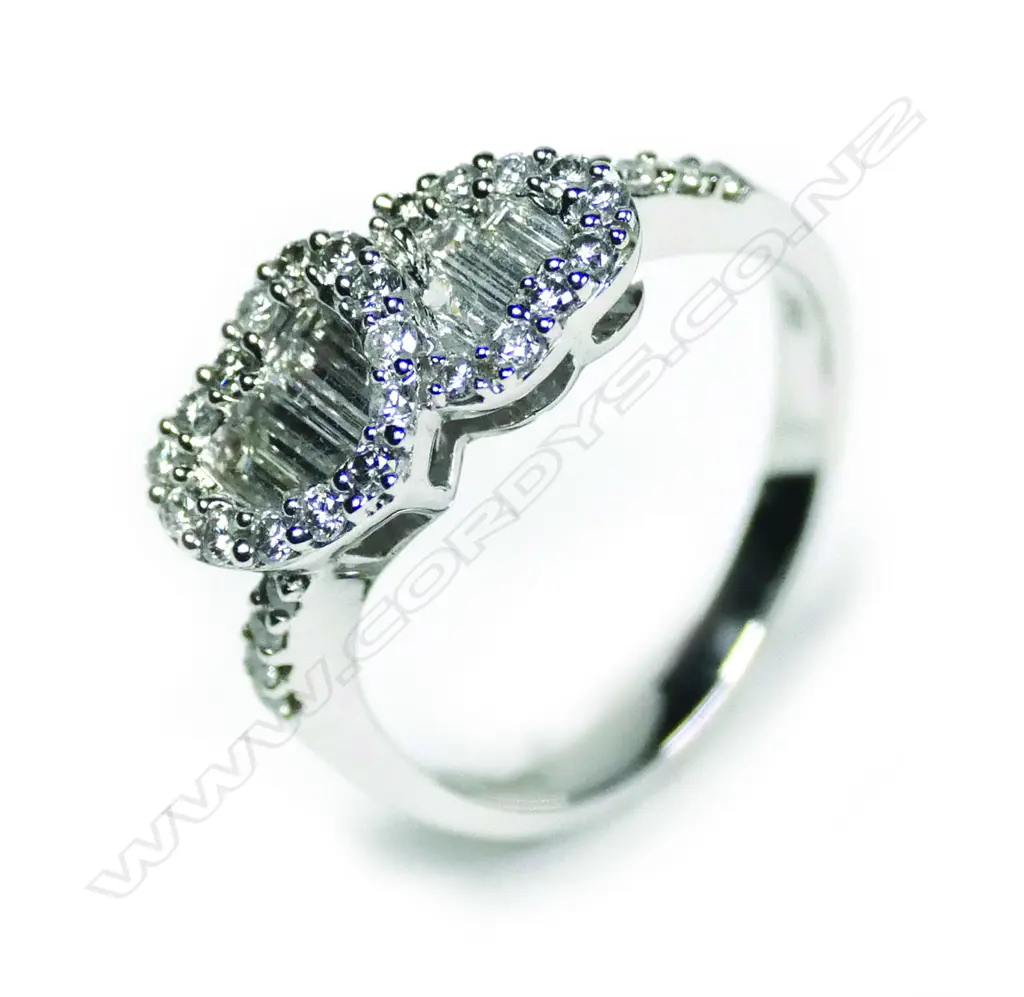 A modern 18ct white gold and diamond twin heart ring Image 1++