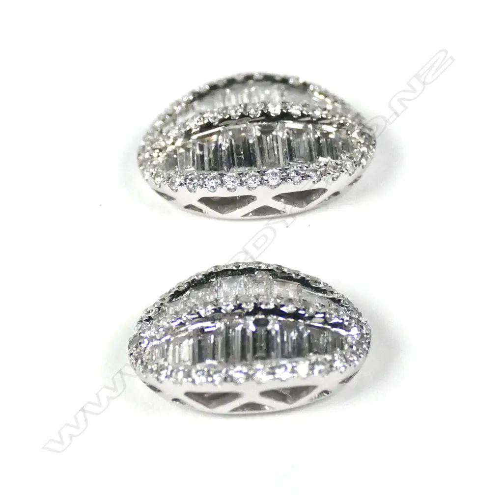 A pair of 18ct white gold and diamond oval shield form cluster earrings Image 1++