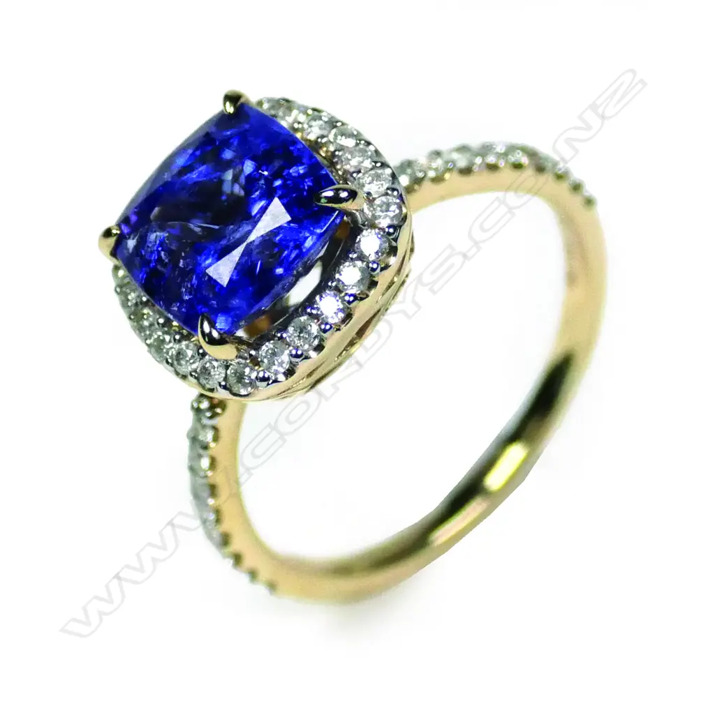 A 14ct yellow gold tanzanite and diamond halo ring Image 1++