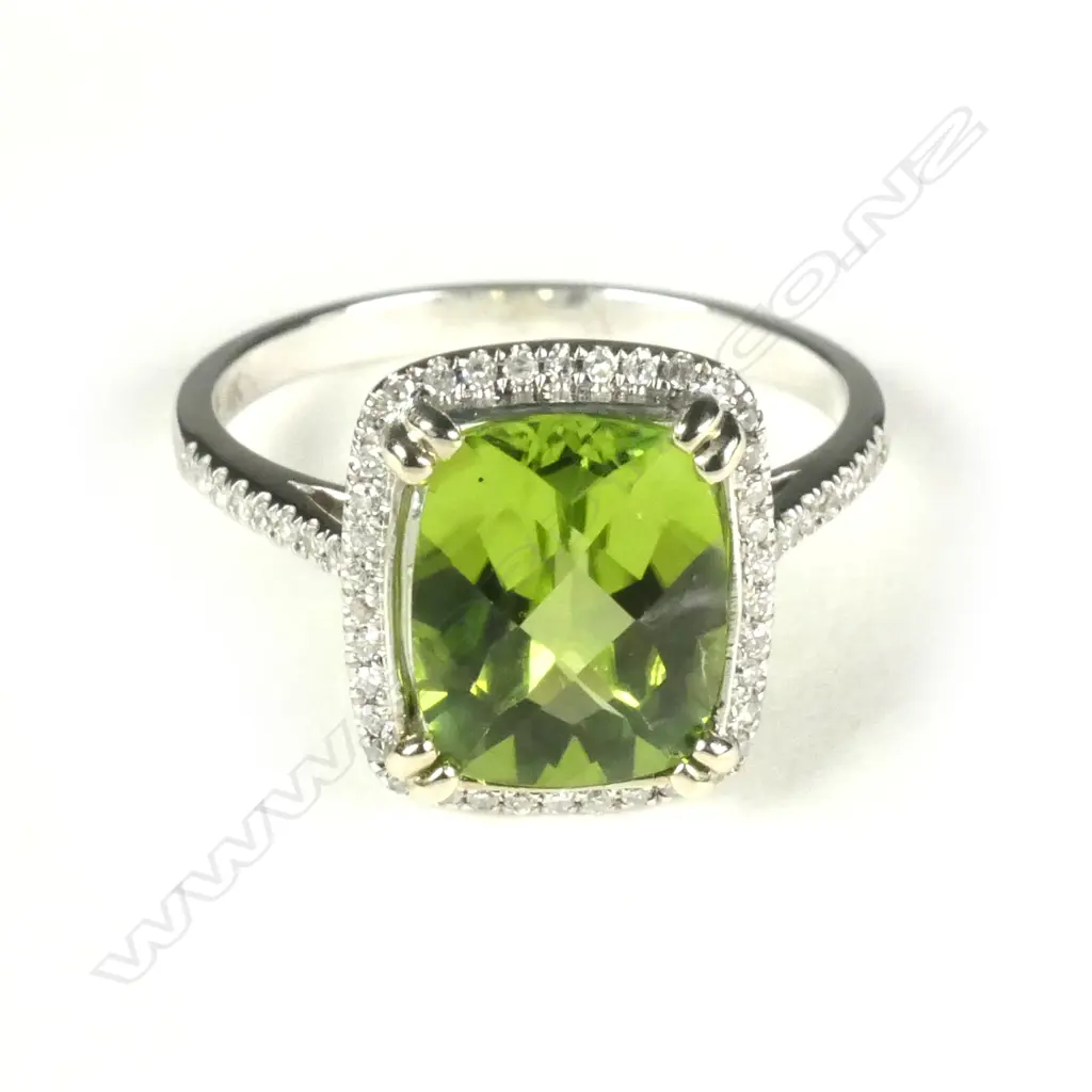 A 14ct white gold peridot and diamond ring Image 1++