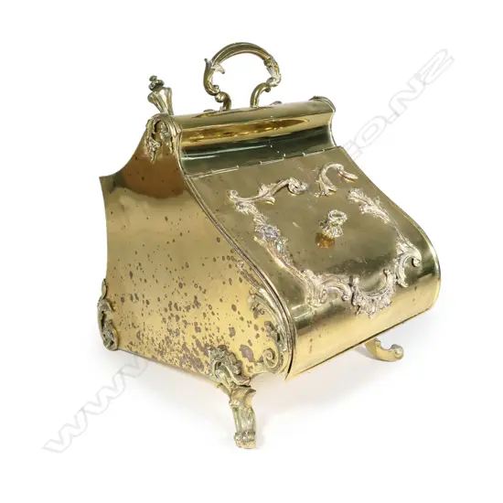 An ornate vintage brass perdonium scuttle
