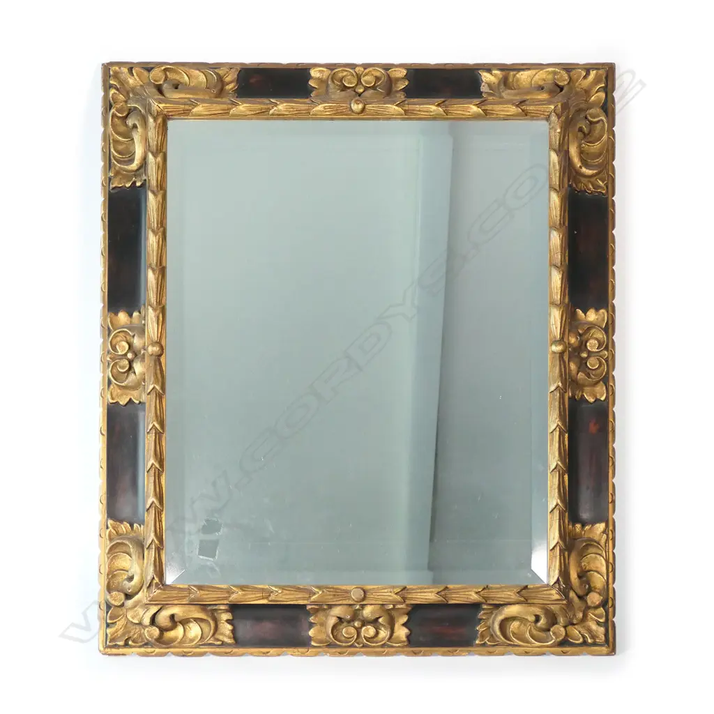 A parcel gilt and ebonized framed bevelled mirror Image 1++