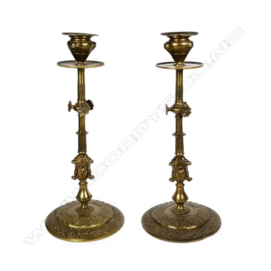 A pair of late Regency style brass candlesticks
