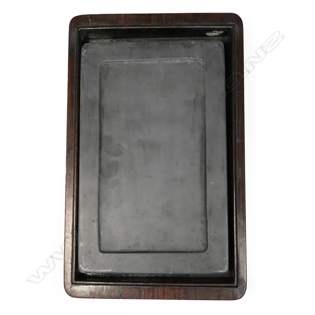 A vintage Oriental hardwood boxed inkstone, rosewood box with inlaid calligraphy to the lid, the inkstone with shaped well framed by a dragon in relief. 245 x 145 x 60mm. Image 1++