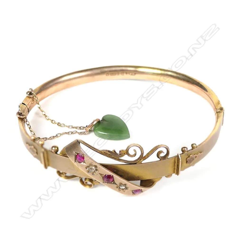 A c.1900 9ct yellow gold diamond ruby and pounamu hinged bangle Image 1++