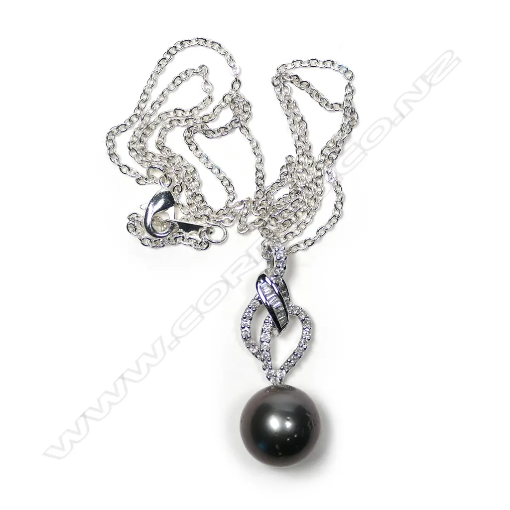 An 18ct white gold diamond and pearl pendant Image 1++