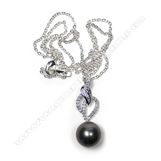 An 18ct white gold diamond and pearl pendant