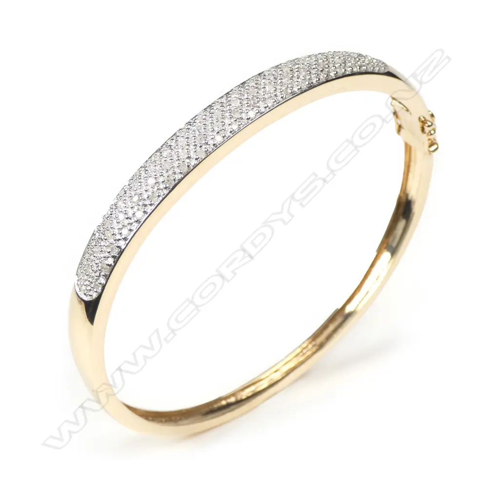 A 9ct gold and diamond hinged bangle Image 1++