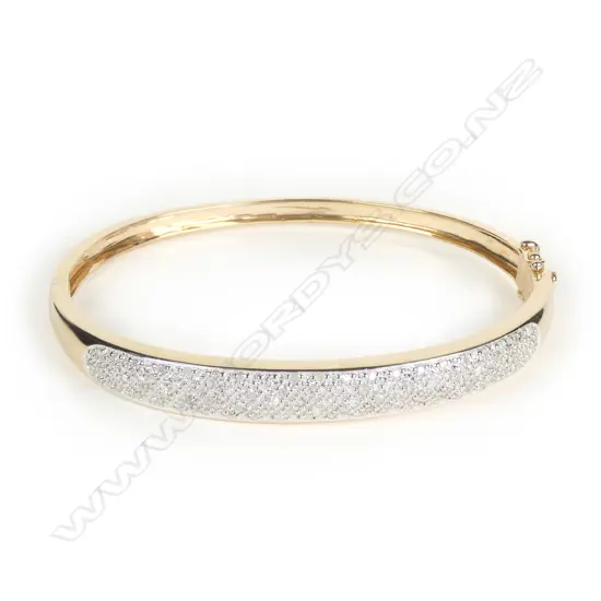 A 9ct gold and diamond hinged bangle