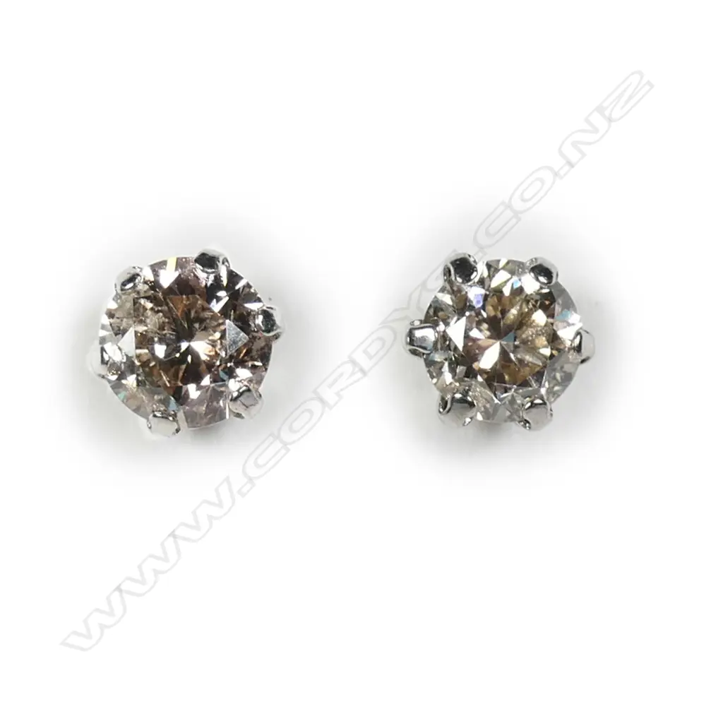 A pair of platinum and diamond stud earrings Image 1++