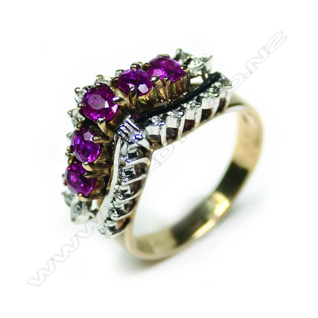 A retro 18ct gold ruby and diamond ring, the exaggerated V-form mount set with five round facet cut rubies framed by 22 small diamonds, 2 absent. Image 1++