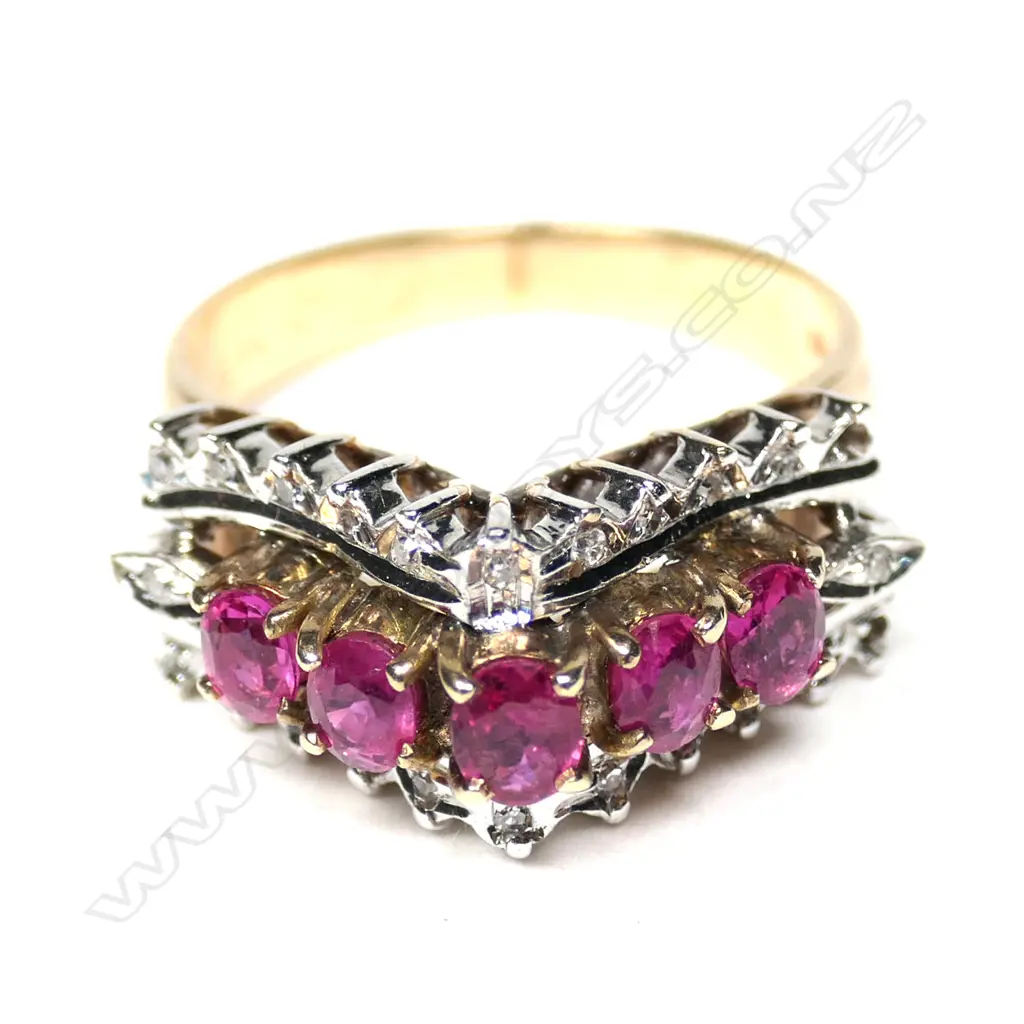 A retro 18ct gold ruby and diamond ring, the exaggerated V-form mount set with five round facet cut rubies framed by 22 small diamonds, 2 absent. Image 1++