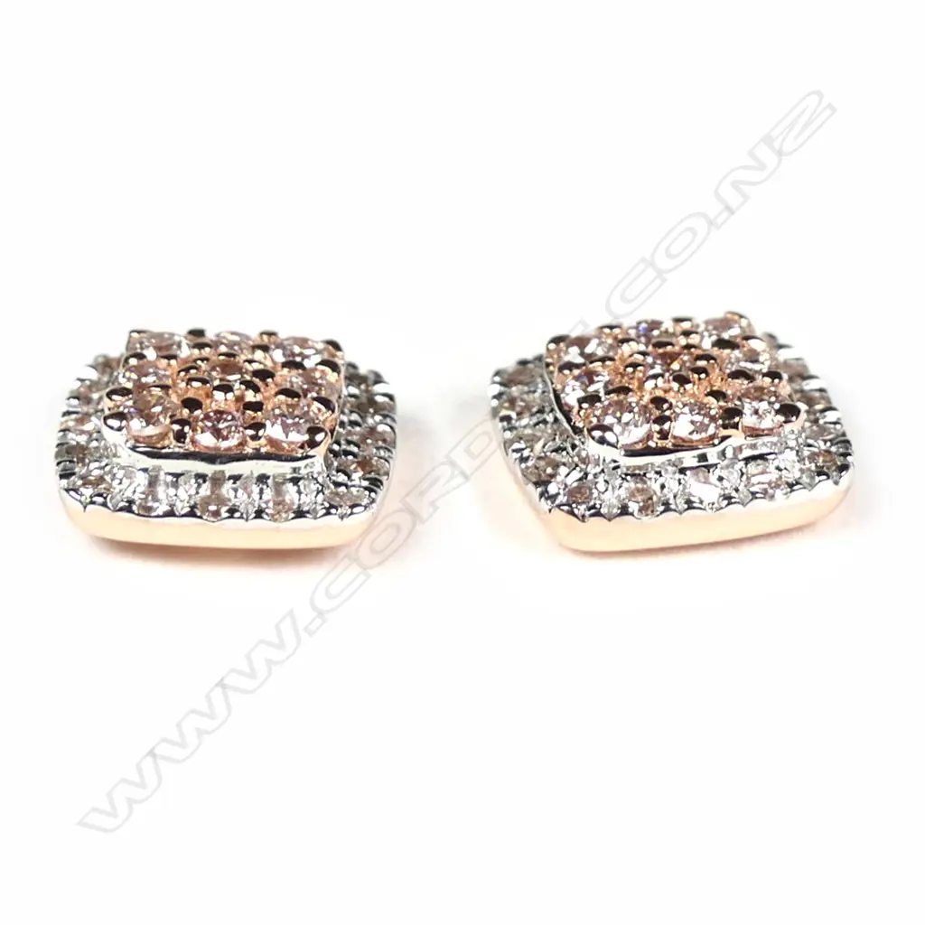A pair of 14ct rose gold diamond stud earrings Image 1++