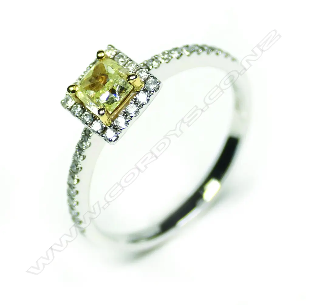 An 18ct white gold yellow and white diamond ring Image 1++